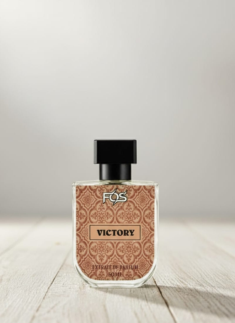 Perfume bottle labeled 'Victory' by FOS on a wooden surface with a light gray background