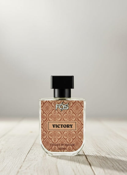 Perfume bottle labeled 'Victory' by FOS on a wooden surface with a light gray background